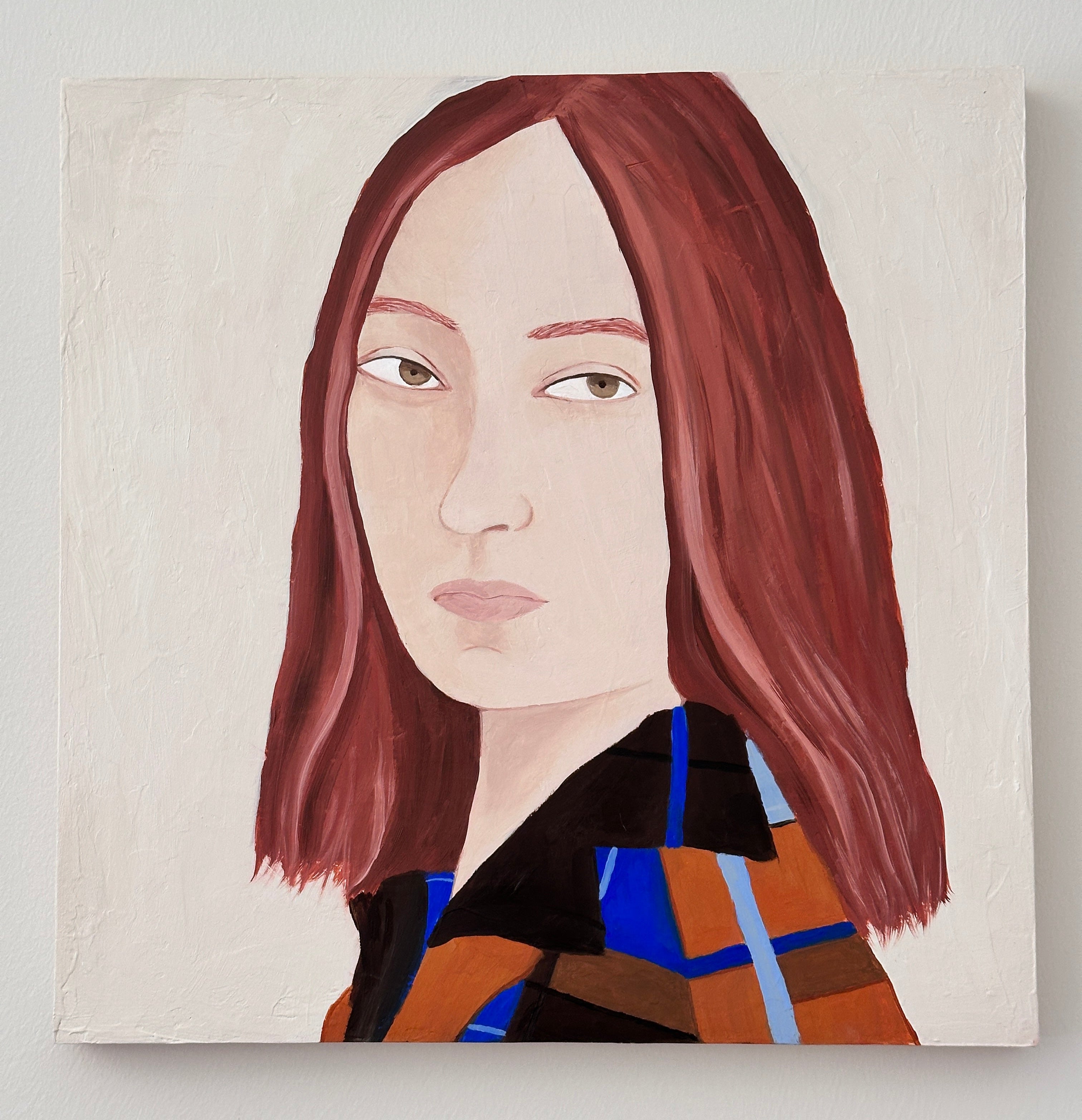 A square portrait painting of a woman with shoulder-length reddish-brown hair, shown against a light neutral background. She wears a dark top with orange, blue, and black plaid sections.